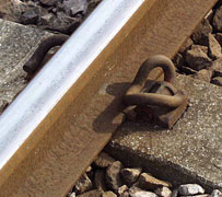 Pandrol clip with cast-in shoulder on concrete sleeper.
